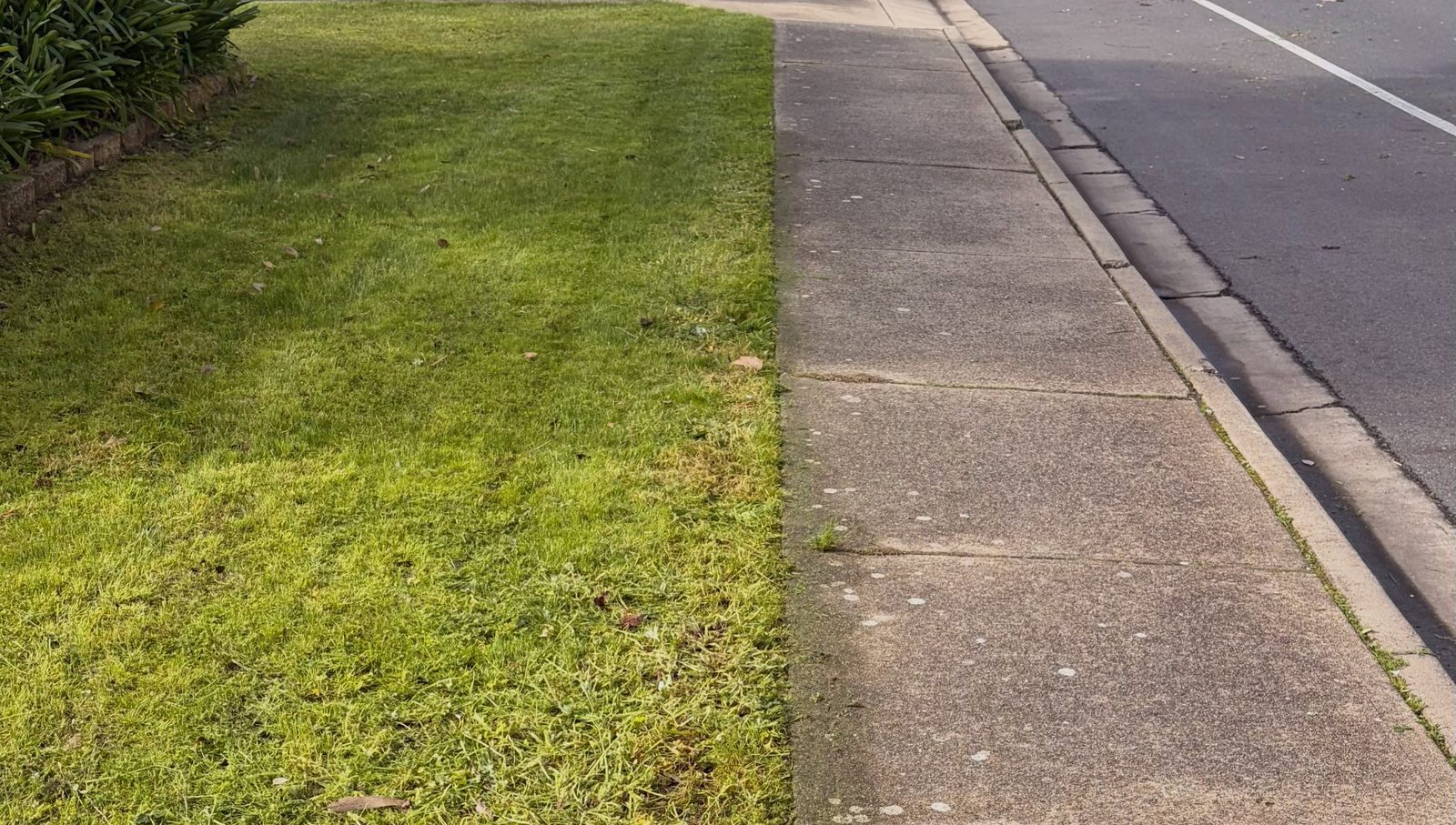 The same footpath with the lawn mowed and a clean cut edge along the concrete